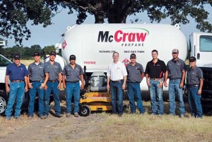 McCraw Oil & Propane employees pose in front of fleet vehicles and equipment that have been converted to propane autogas.