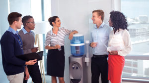 Employee around water cooler stock: Spend some casual time around the water cooler, strike up a personal conversation. Photo iStock.com/Wavebreakmedia