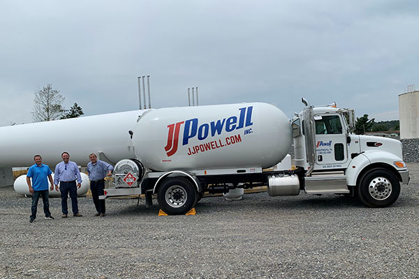 Brandon Duff, operations manager, Doug MacMaster, consultant, and Eric Hussar, director of HVAC sales, pose with one of JJ Powell's bobtails. Photo by Dan Herman