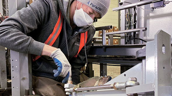 Fabrizio installs a new piece of equipment in Paraco Gas’ Waterbury, Connecticut, refurbishing facility. Photo by Paraco employee