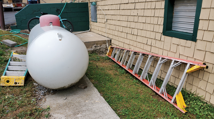 This propane tank is placed too closely to a retail storage and services building. (Photo by Richard Fredenburg)