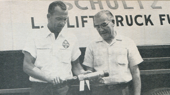 Photo of Don Schultz and the safe-fill gun he designed