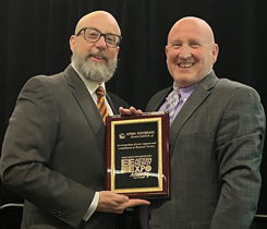 Scott Fenwick (left), technical director of Clean Fuels Alliance, accepts a plaque, on behalf of Business Partner Iowa Soybean Association, from Eric DeGesero, executive vice president of Fuel Merchants Association, acknowledging their support as Business Partner for this year’s event. (Photo courtesy of Eastern Energy Expo)