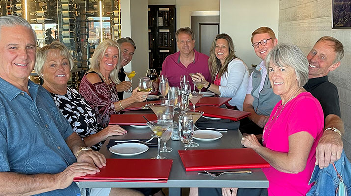 Andrew Hartmann, center, celebrates with friends and family at the closing dinner. (Photo courtesy of Cetane Associates) _ Haffner's acquires Hartmann