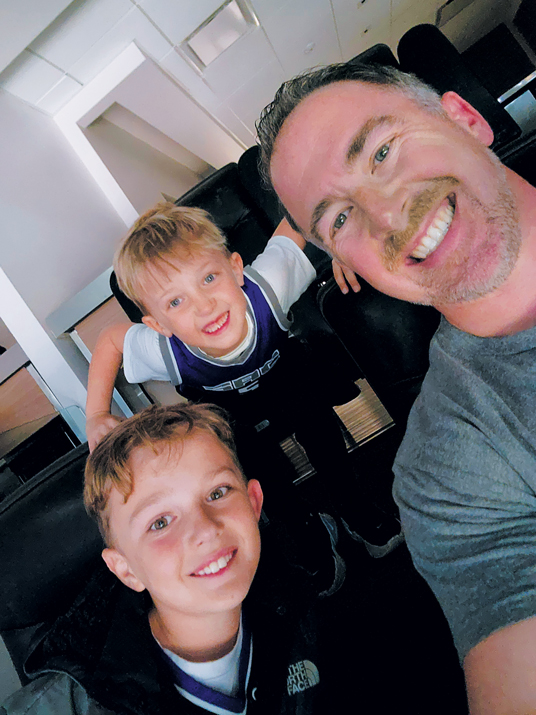 Sueyres likes to spend time with family and volunteer his time. Here, he’s with his sons, Fitzgerald and Lincoln, at a Sacramento Kings game. 