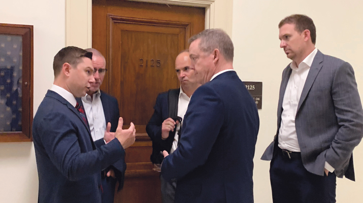 The huddle: Alex Boehnke, left, talks with Ohio delegates from Worthington Enterprises. (Photo: LP Gas staff)