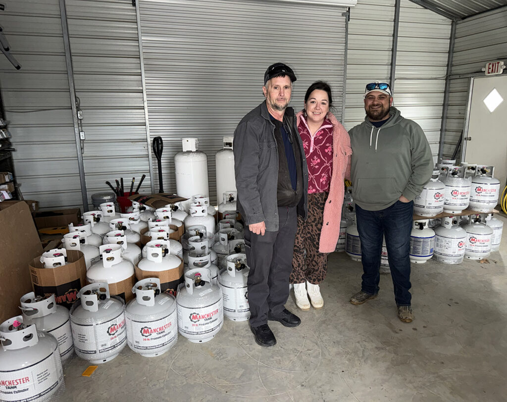 Photo of propane industry members amid donations of propane cylinders
