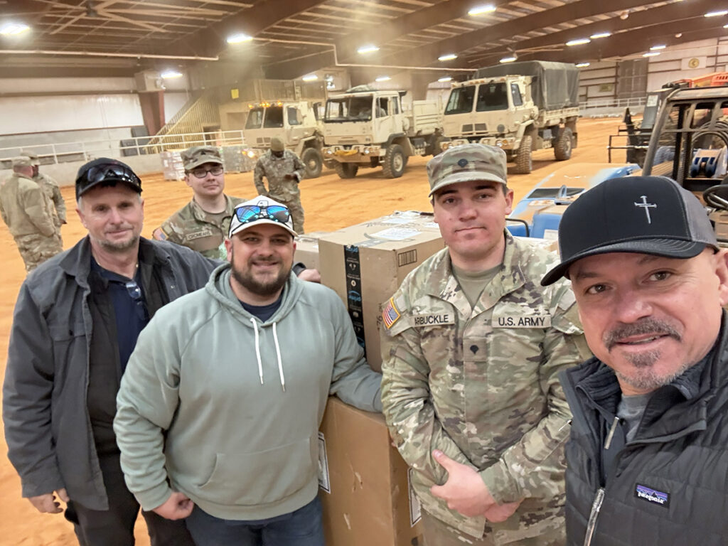 Photo of Army National Guard members and others helping with donations in northern Mississippi.