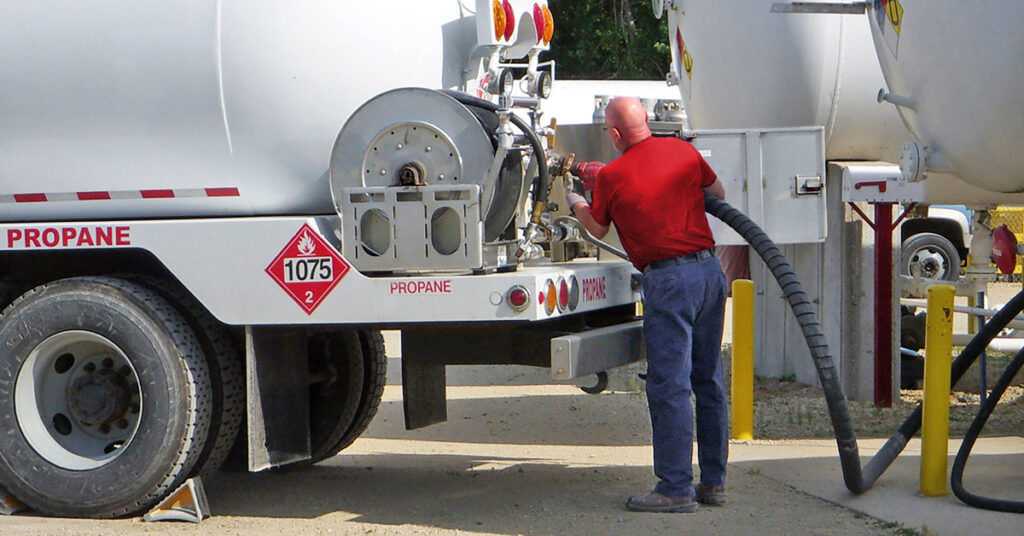 Man using Hannay Reel to fill up propane truck.